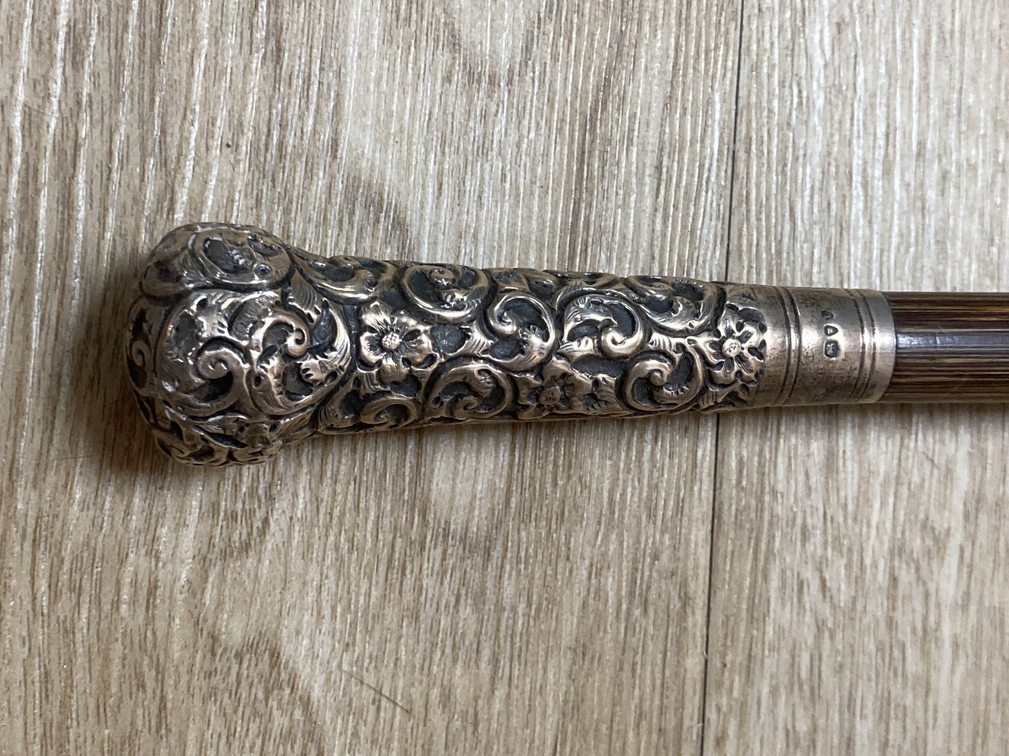 An Indian silver mounted walking cane, 91cm, and a silver mounted umbrella
